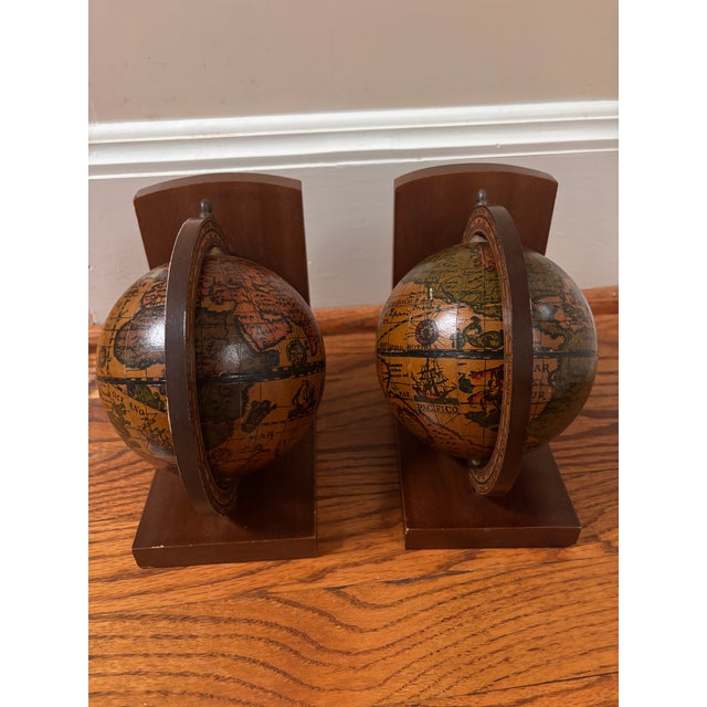 Classic Pair of old world style book ends made in Italy. Globes are mounted on L shaped bases Walnut, circa 1970's Each...