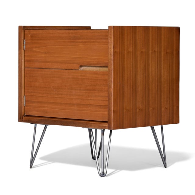A refined pair of Mid-Century Modern walnut nightstands, American-made and likely dating to the early 1960s. These...