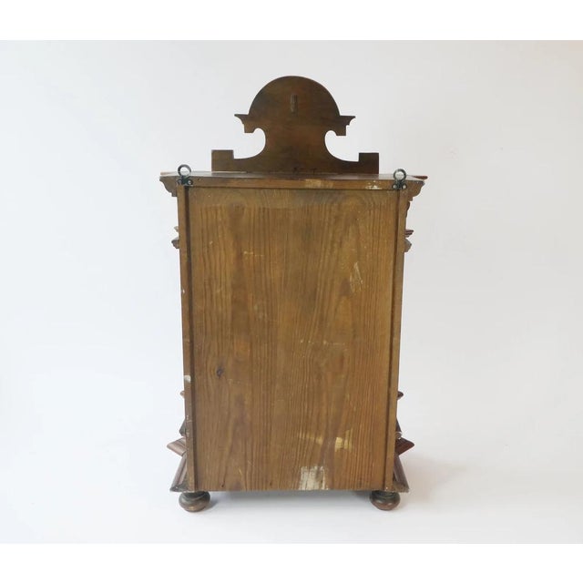 Stunning German antique cabinet from the early 1900's with many carved ornaments overall. It has a door with a unique...