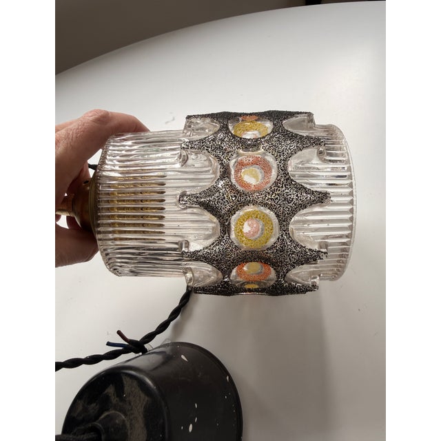 vintage mid-century modern glass pendant light likely from the 1960s or 1970s. The unique design features a clear, ribbed...