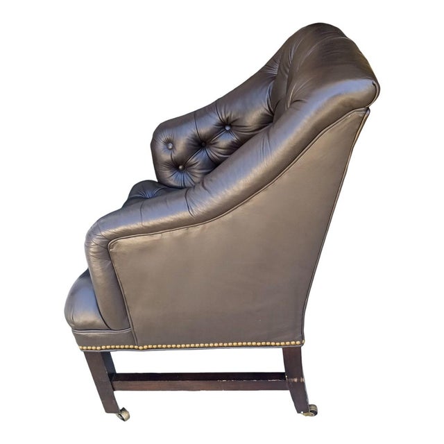 Experience the height of classic luxury with this leather Chesterfield chair with elegant brass nailhead trim. Crafted for...
