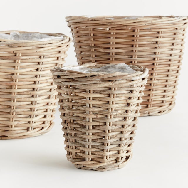 Woven by hand in a thick Kubu rattan that is claydyed & dried in the sun, these sturdy tapered basket planters are the...
