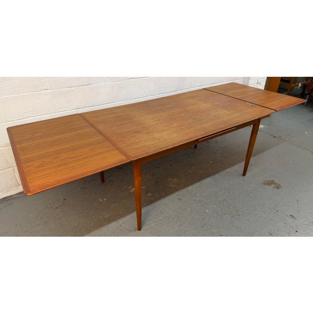 Timeless Danish Mid-Century Modern draw-leaf dining table designed by Skovmand & Andersen for Moreddi, showcasing the...