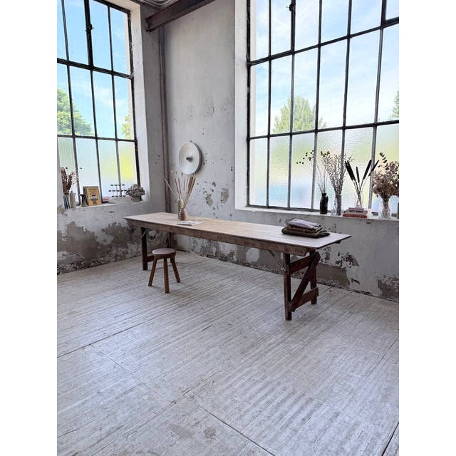 Vintage 1950s folding pine farmhouse or bistro table. it consists of a pine top resting on a retractable base. we...