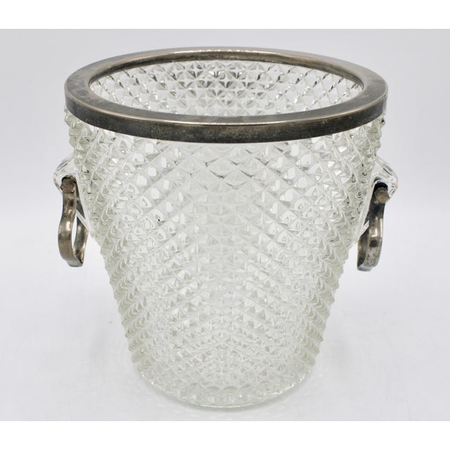 A stunning Mid 20th Century English Crystal Ice Bucket with Silver Plate Handles and rim. This is an exquisite ice bucket...