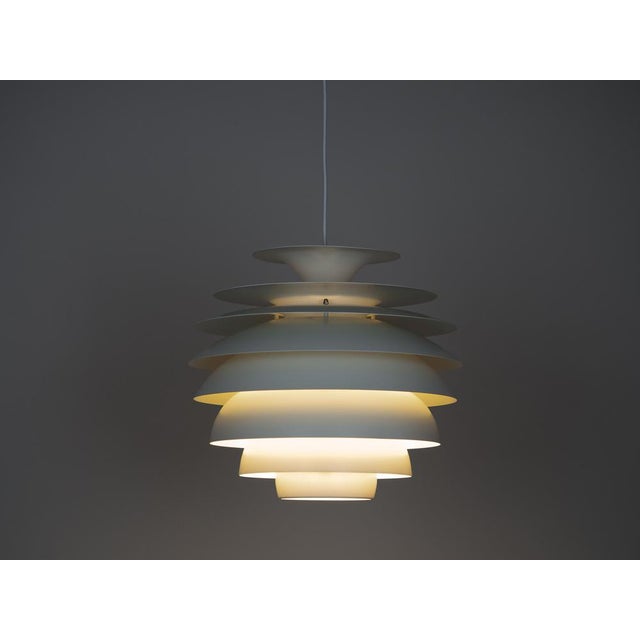 The Barcelona lamp by Bent Karlby is an elegant 1960s ceiling lamp made of aluminum. It features a minimalist, geometric...