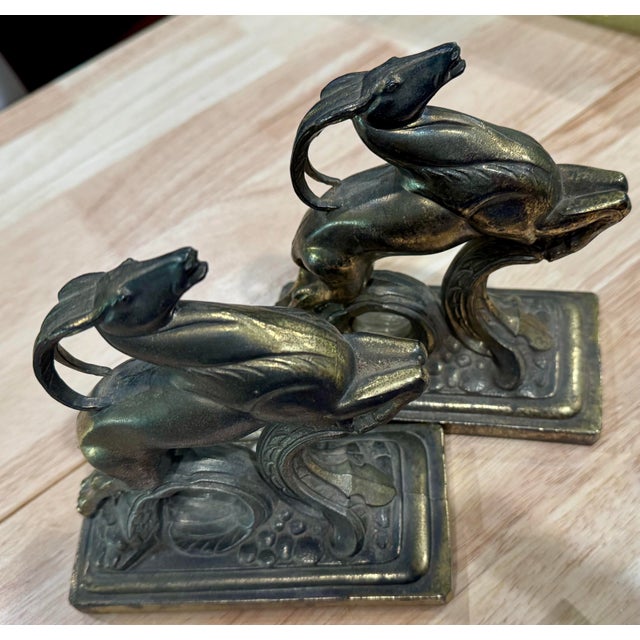 An exceptional pair of authentic, heavy cast iron bookends featuring a highly stylized "Leaping Gazelle" (Ibex) motif,...