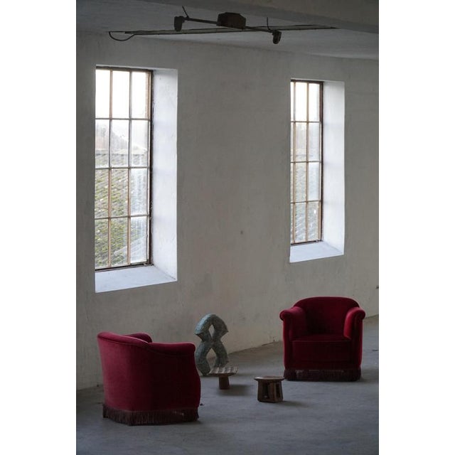 A stunning set of Danish lounge chairs from the 1950s, featuring a sculptural, rounded form and generously padded seats,...