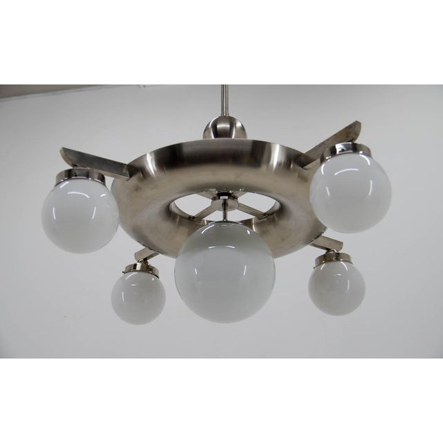 Very rare large bauhaus 9-flamming nickel-plated chandelier designed by franta anyz and executed by ias in late 1920s....