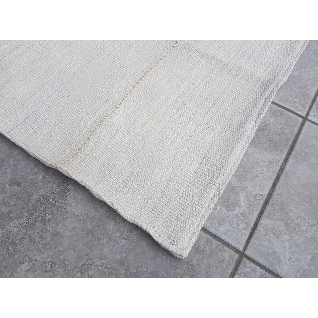 This is a vintage Turkish Anatolian kilim rug from the 1960s. The piece was hand-woven.