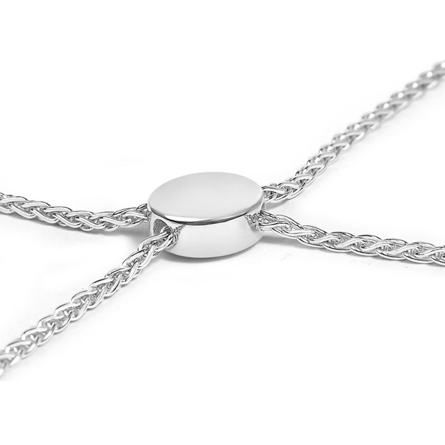 With its gracefully intertwined ribbon and circle motif, this exquisite bracelet is a masterpiece crafted from rhodium-...