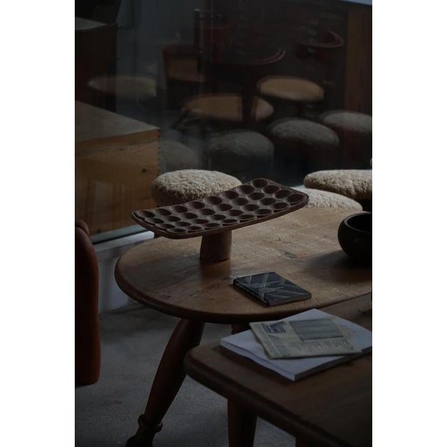 A beautiful and authentic African game board, hand-carved from a single piece of wood and elevated on a central foot,...