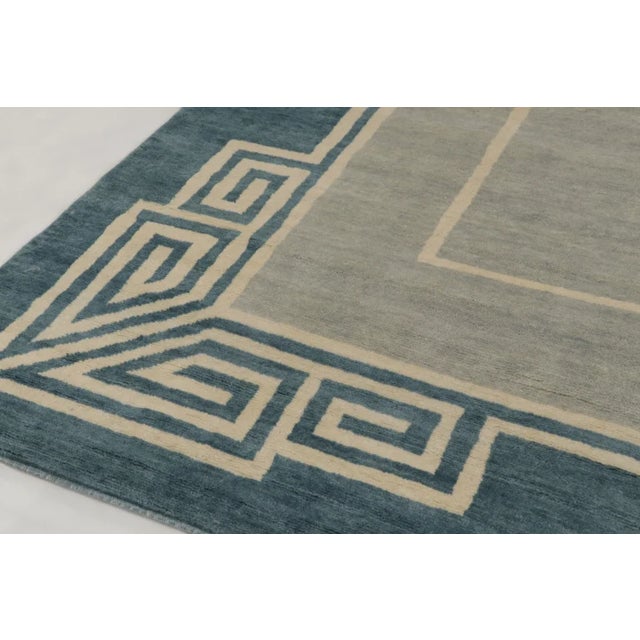 This oversized 11x17 contemporary rug is a captivating addition to Rug & Kilim’s Art Deco collection—an architectural...