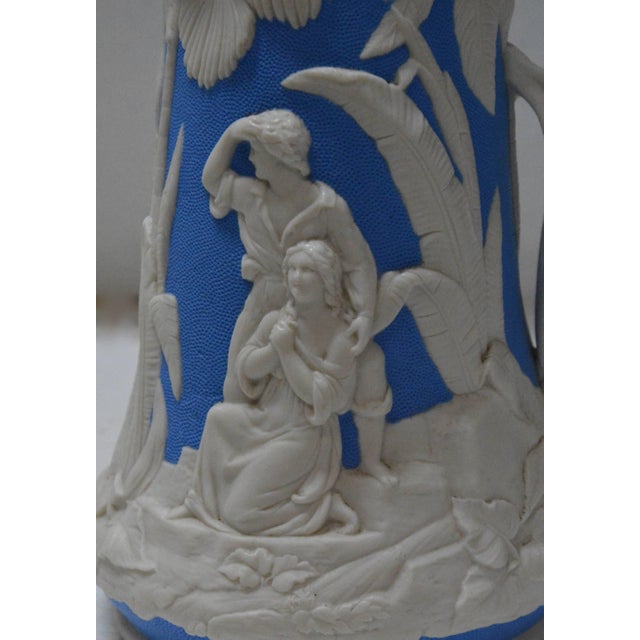 A beautiful molded earthenware pitcher made by the Jones and Walley Co. of Cobridge, Stoke-on-Trent, England. The piece...