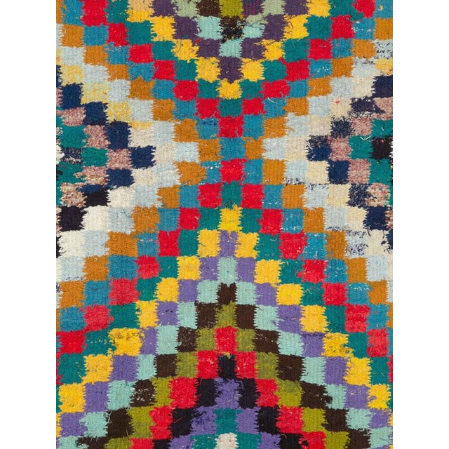 This Mid-20th century Persian flatweave kilim presents a striking geometric composition formed from countless small,...