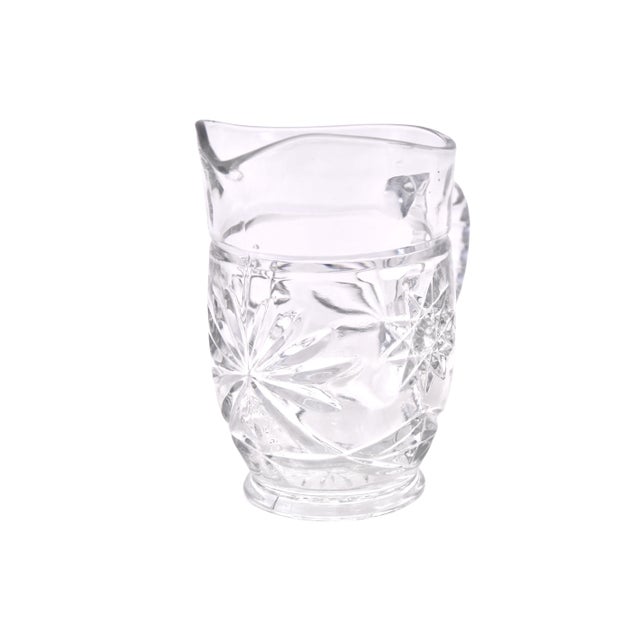 Star pattern clear glass pitcher shape vase. No maker's mark. Light wear.