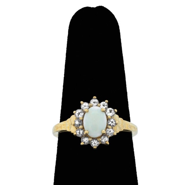 Opal and Tanzanite 10K Yellow Gold Jewelry Set, including one ring adorned with one white opal cabochon weighing approx....
