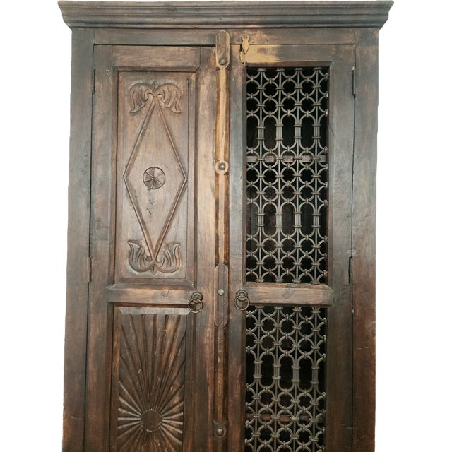 This antique cabinet is a unique piece of Indian furniture art, crafted from solid wood. This authentic, one-of-a-kind...