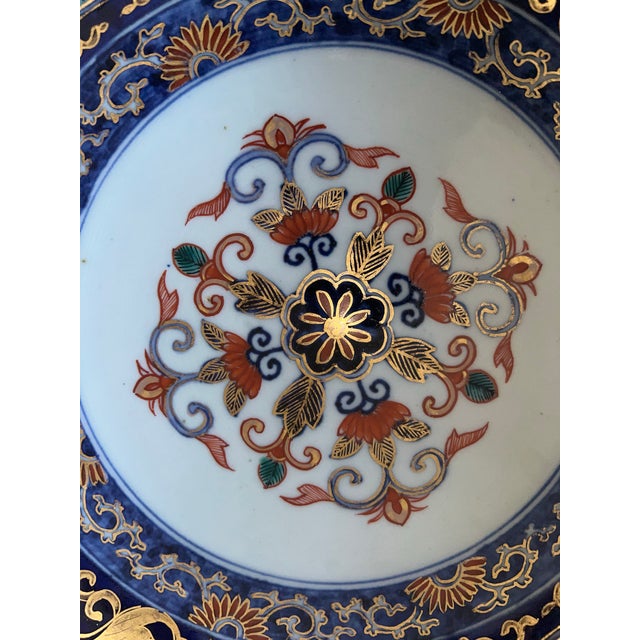 This is a Japanese Imari porcelain bowl with a traditional pattern. Imari ware is a style of Japanese export porcelain...