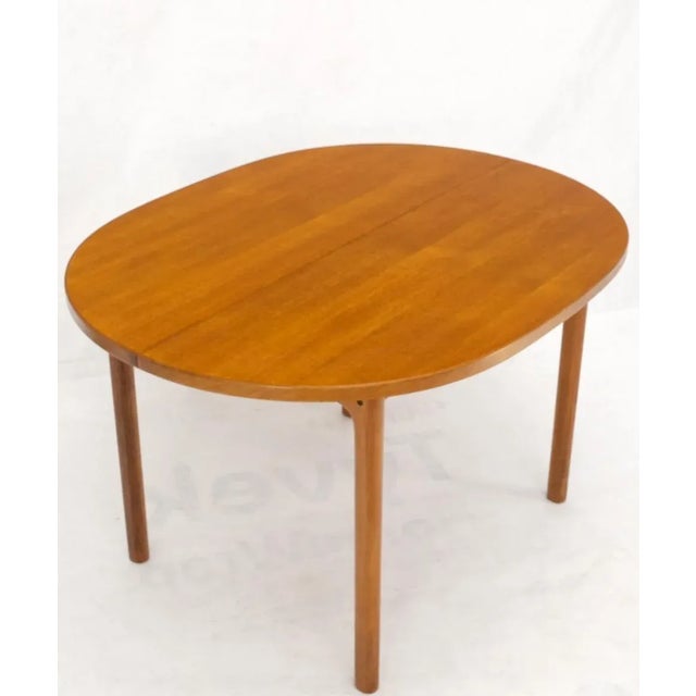 Compact teak Danish Mid-Century Modern dining table w/ large 20" long leaves extensions. Extends up to 78" long.