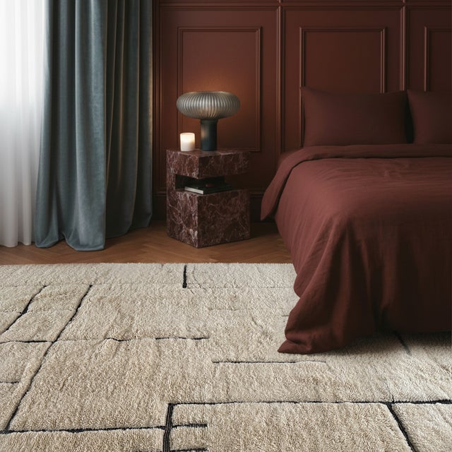 A study in restraint — thin, freehand jet black lines trace a loose architectural grid across a soft ivory field, sparse...