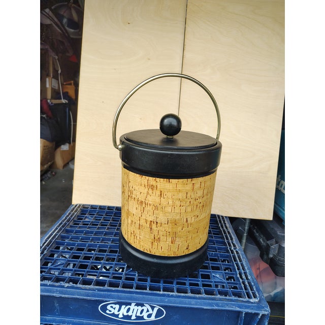 this ice bucket is in excellent condition cork and steel barrel,black vinyl top A1nd bottom wrapped and a vinyl wrapped...