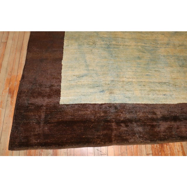 Mid 20th century Turkish Anatolian with a plain shadow life design in blues creams and yellow surrounded by a dark brown...