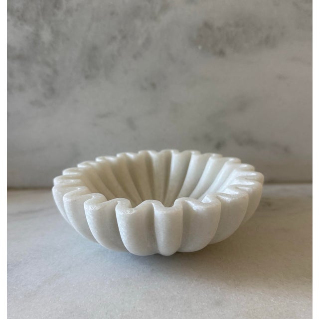 Beautiful white marble stone bowl with an unique "ruffled" edge. Wonderful as a soap dish, catchall for coins, keys or...