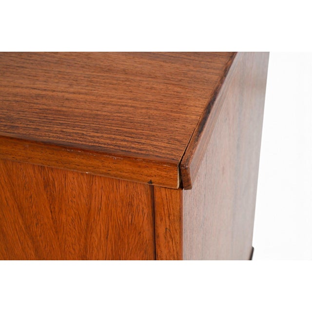 A Danish rosewood sideboard dating to the 1960s, with a long, low profile and a T-base that lends the cabinet a lighter...
