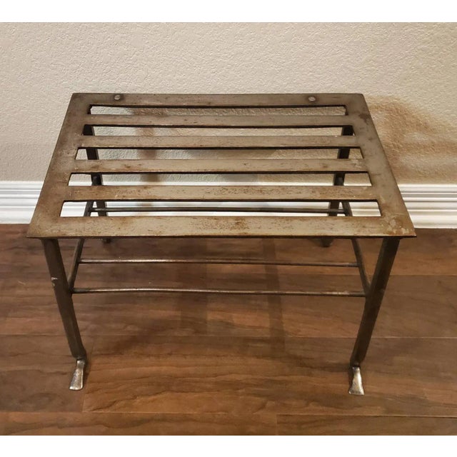 A wonderful English polished steel two tier fireplace footman / stool / trivet with slatted seat and medial shelf. Very...