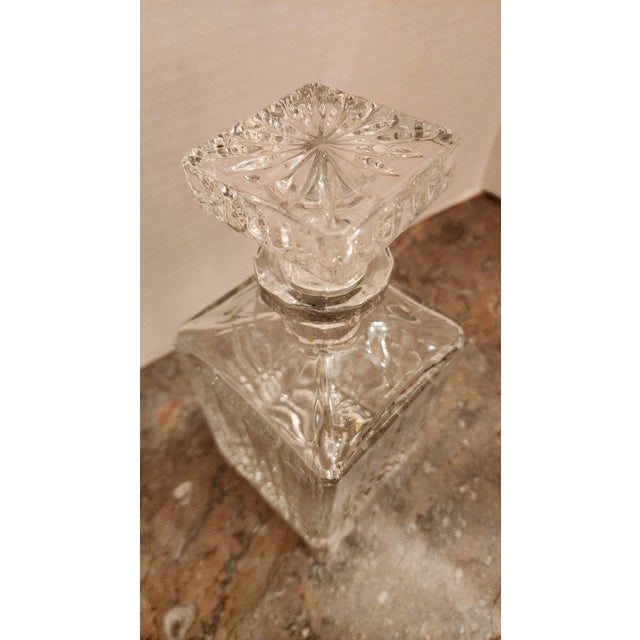 Vintage clear glass decanter with square stopper