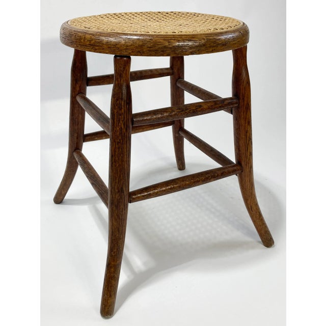 Antique early 1900s cane top Sprague leg bentwood stool. Features a rich natural finish to oak frame. Seat 13.5"dia. Minor...
