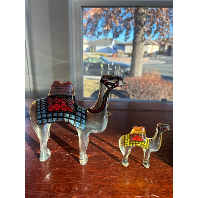 A set of 2 Mid-Century Modern lucite op Art camels designed by Abraham Palatnik. Original label on bottom: Made in Brazil....