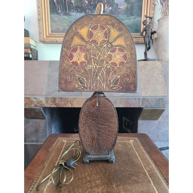 Fabulous 1920s table lamp with a yellow crackle glass base and hand-painted Mica shade. Each side of the shade features a...