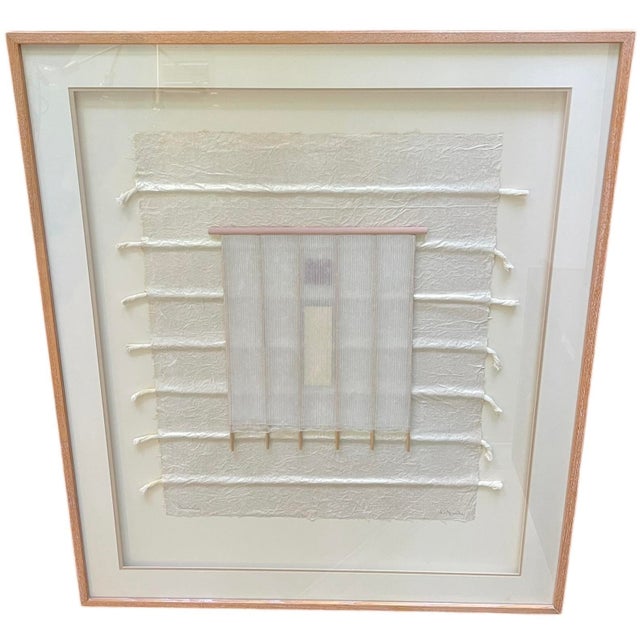 Oversized signed textile fiber art featuring layered natural materials in a soft neutral palette. The dimensional...