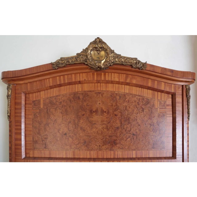 Large mirror in the Louis XVI style decorated with bronze gilded applications, inlays of various fruit woods and spices,...