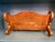 This decadent piece features high-relief floral carvings, scrolling volutes, and a distinct combination of gold gilding...