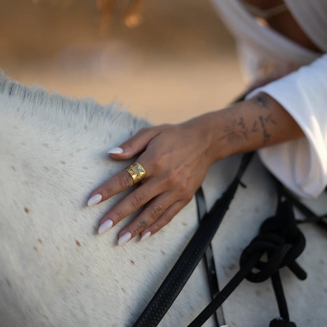 Bring the magic of the ocean to your style with the Turquoise Starfish Gold Adjustable Cuff Ring. This bold yet elegant...