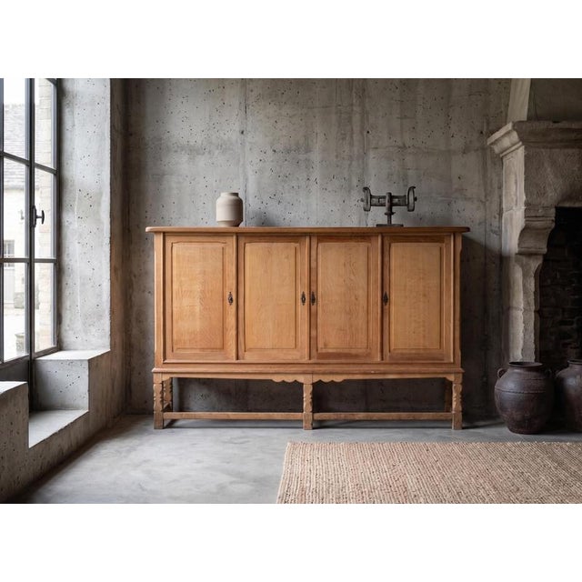 A striking high oak sideboard from Denmark, dating from the 1970s and attributed to the renowned Danish designer Henning...
