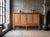 A striking high oak sideboard from Denmark, dating from the 1970s and attributed to the renowned Danish designer Henning...