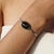 A sculptural black star cabochon bracelet in 925 sterling silver, defined by its singular, statement-making form. The...