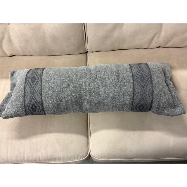 Design Plus Gallery presents the Textured Gray Bolster Pillow. The rectangular form is upholstered in a heathered gray...