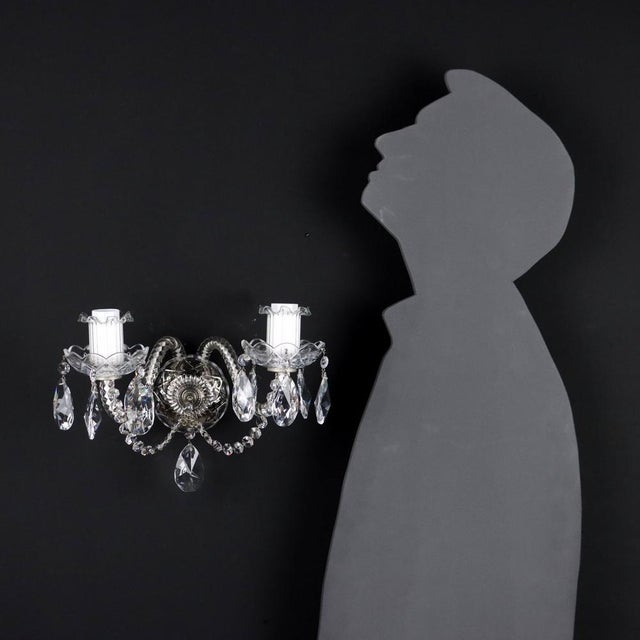 Two-light wall sconce with crystal arms, bobeches and pendants. Italy 20th century. This piece is attributed to the...
