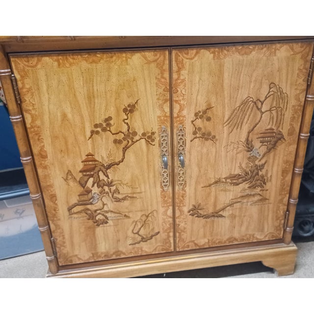Beautiful 1970's chinoiserie faux bamboo trimmed cabinet. One moveable shelf inside makes it easy to adjust for storage....