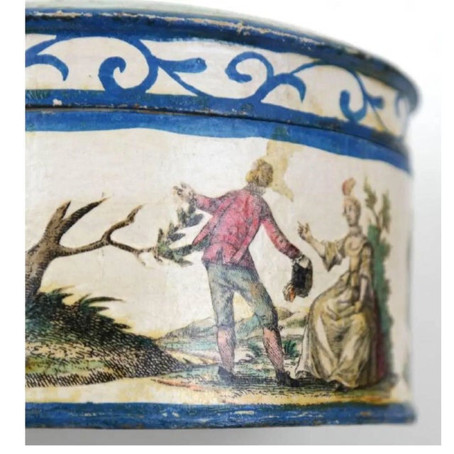 The round box with white ground and decals painted through out. Made in the mid 18th century.