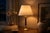 A refined vintage table lamp combining warm polished brass with a rich burgundy lacquered central column, creating a...