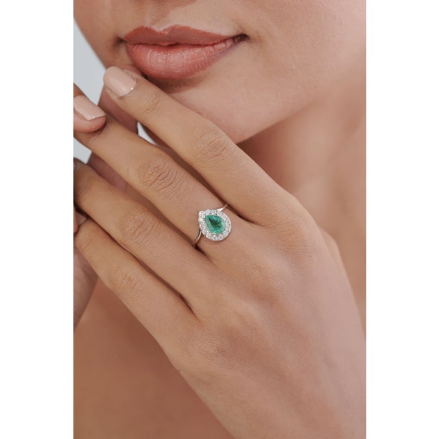 This Statement halo ring features 1.15 ct natural pear-cut emerald, set in 14K white gold. The emerald measures 7.5 × 6 mm...