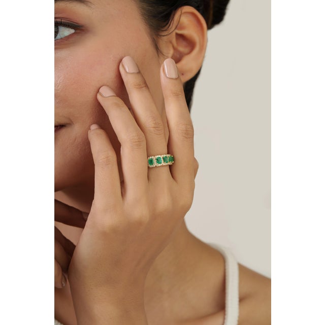 This statement band ring featuring 1.31 carat octagon-cut emeralds set in 14K yellow gold. Each emerald measuring...