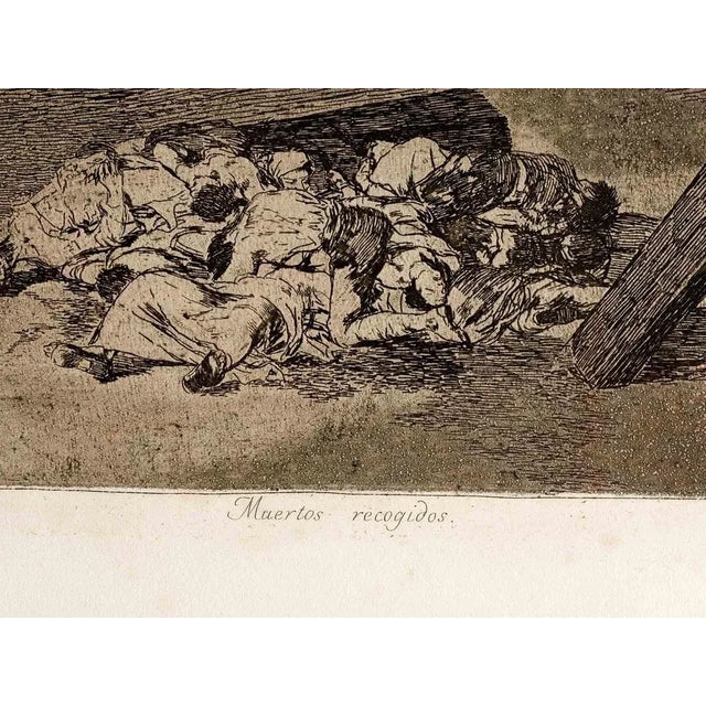Muertos recogidos is an original modern artwork realized by Francisco Goya in 1810. Third edition Black and white etching....