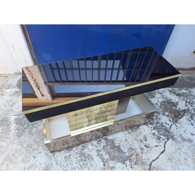 Mobile bar on wheels made by Stilglass Donati in the 70s. The cabinet is made of wood, with brass inserts and mirrored...